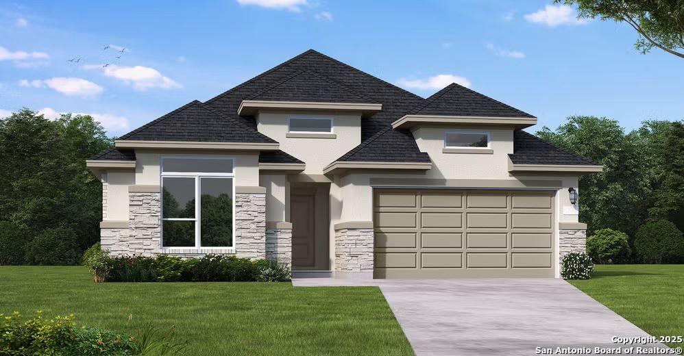 view of front of property with a garage and a front lawn