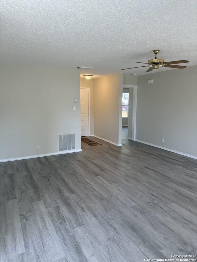 spare room with ceiling fan, wood-type flooring, and a textured ceiling