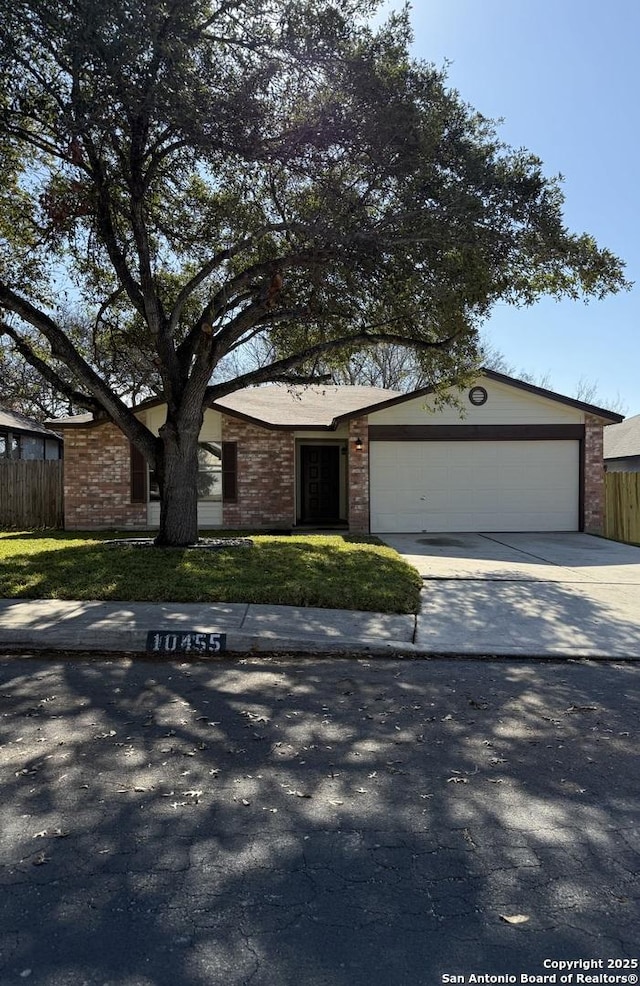 ranch-style home featuring a garage and a front yard