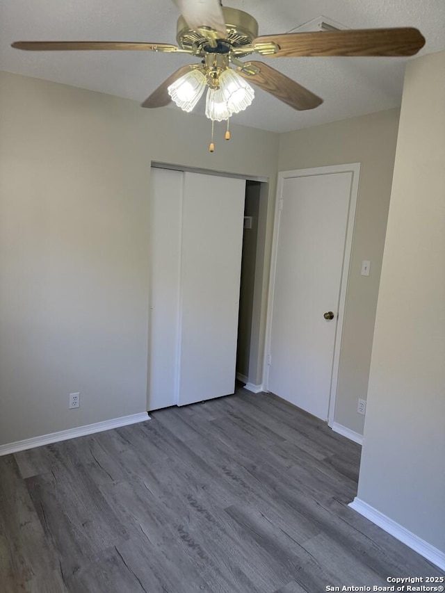 unfurnished bedroom featuring a closet, ceiling fan, and hardwood / wood-style floors