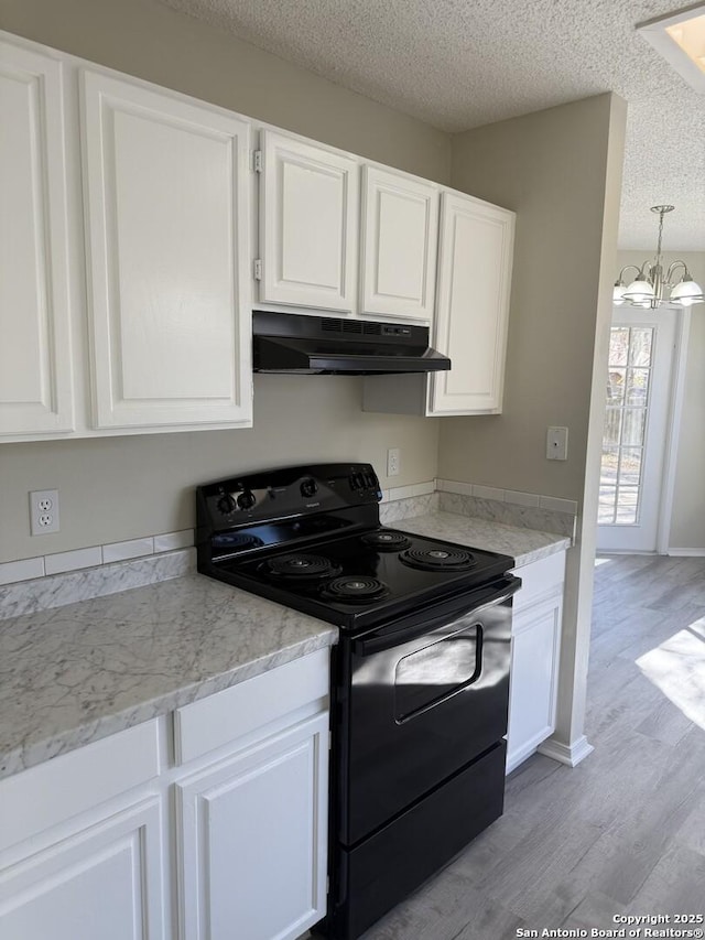 kitchen with a chandelier, light wood-type flooring, electric range, and white cabinetry