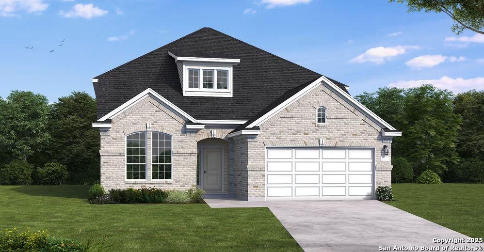 view of front of house featuring a front lawn and a garage