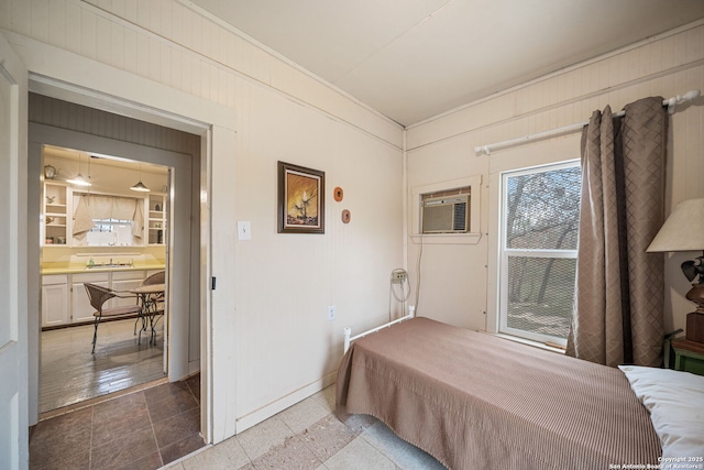 bedroom featuring wooden walls