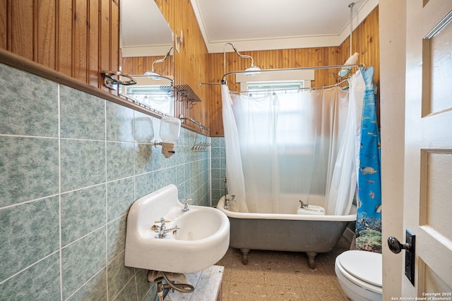 full bathroom featuring sink, crown molding, toilet, shower / bath combo with shower curtain, and tile walls