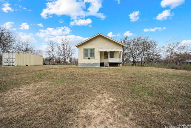 back of house with a lawn