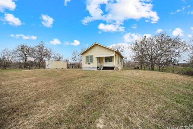 back of property featuring a yard