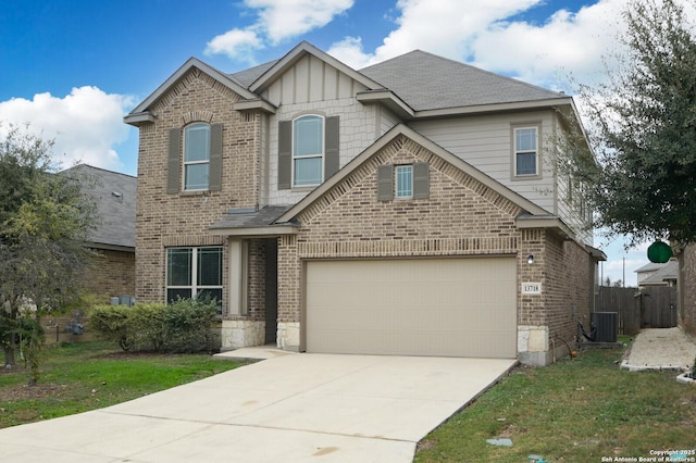 view of front of home featuring central air condition unit, a front yard, and a garage