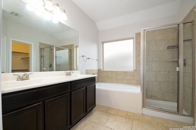 bathroom with lofted ceiling, vanity, tile patterned floors, and independent shower and bath