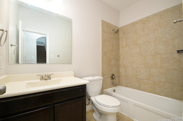 full bathroom featuring tile patterned floors, vanity, tiled shower / bath combo, and toilet