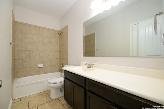 full bathroom with tile patterned floors, vanity, tiled shower / bath, and toilet