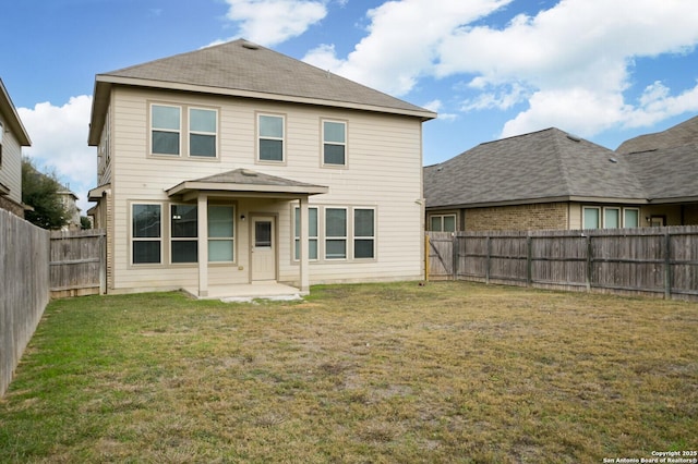 rear view of property with a lawn