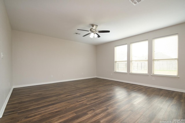 spare room with dark hardwood / wood-style flooring and ceiling fan