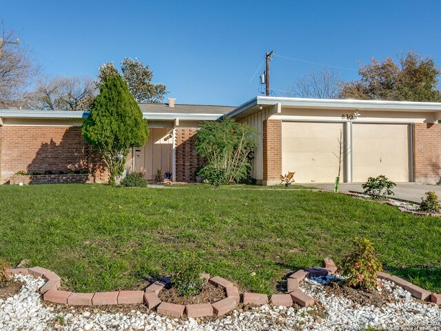 exterior space featuring a front lawn and a garage