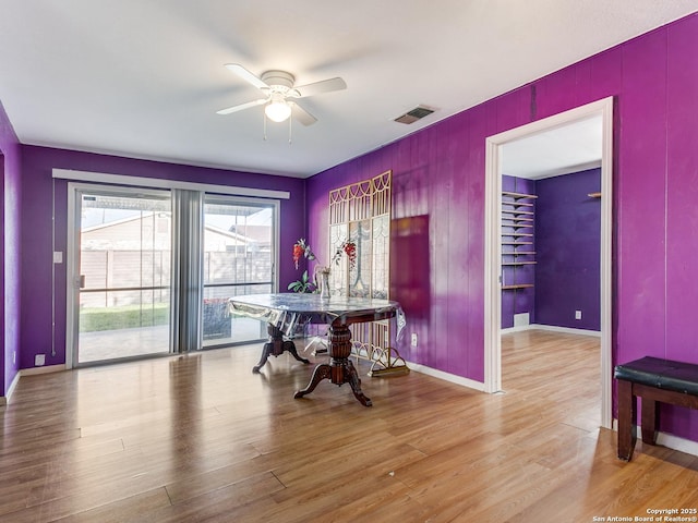 dining room with ceiling fan and light hardwood / wood-style floors