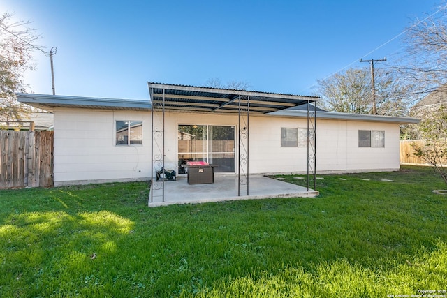 back of property featuring a yard and a patio