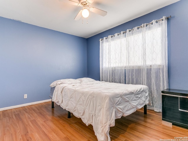 bedroom with hardwood / wood-style floors and ceiling fan