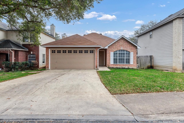 view of front of home featuring a front yard and a garage