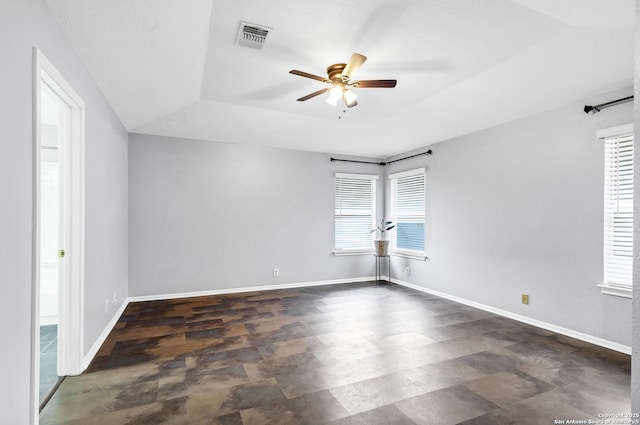 empty room with ceiling fan and a textured ceiling