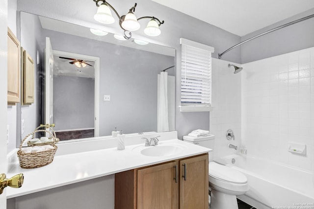 full bathroom with ceiling fan, toilet, vanity, and shower / tub combo with curtain