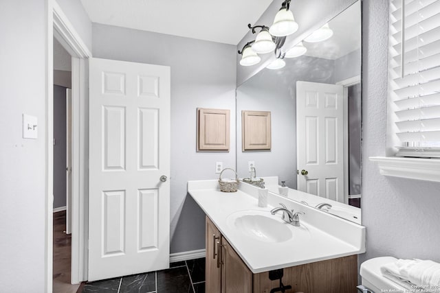 bathroom with vanity and toilet