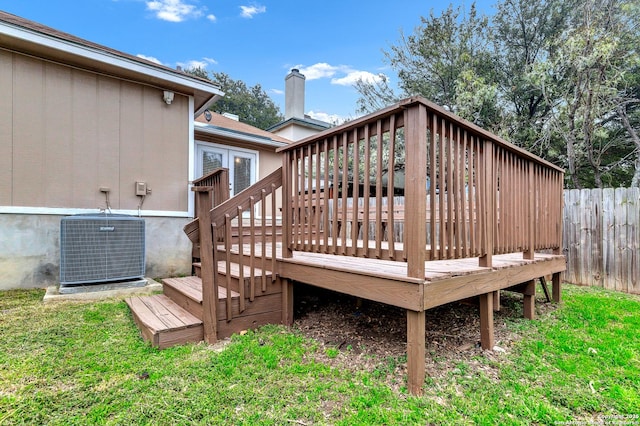 deck featuring a yard and cooling unit