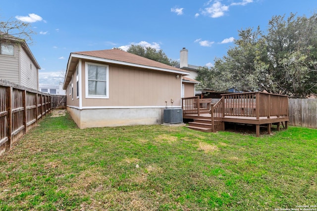 back of property featuring a yard, central AC, and a deck