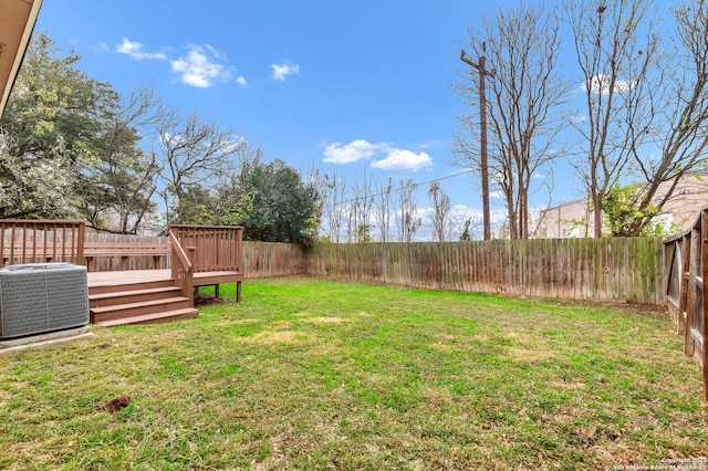 view of yard featuring central air condition unit and a deck