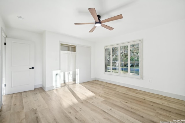 unfurnished bedroom with ceiling fan, a closet, and light hardwood / wood-style flooring