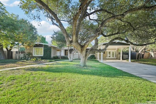 ranch-style home featuring french doors and a front lawn