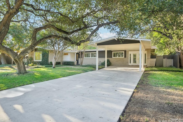 ranch-style house with a carport and a front yard