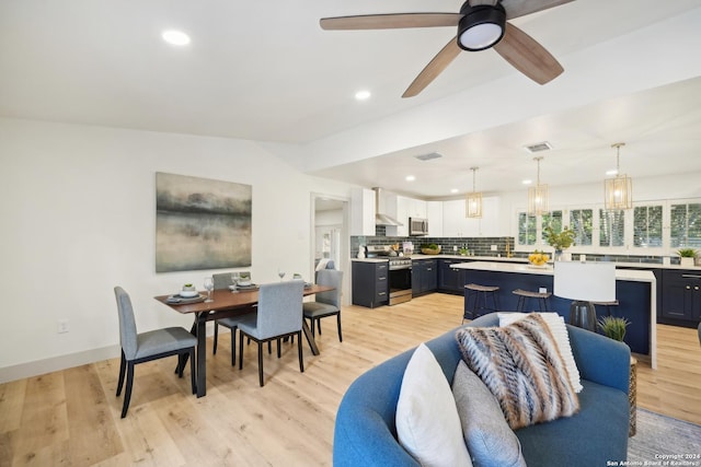 living room with light wood-type flooring and ceiling fan