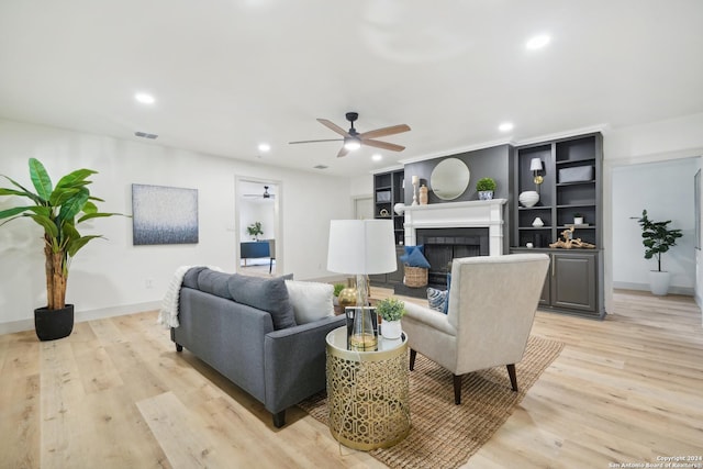 living room featuring ceiling fan and light hardwood / wood-style flooring