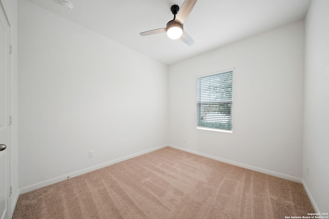 empty room featuring ceiling fan and light carpet