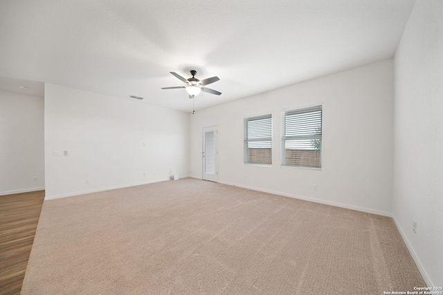 carpeted empty room featuring ceiling fan