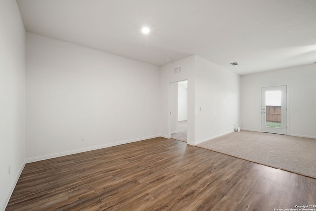 spare room with dark wood-type flooring