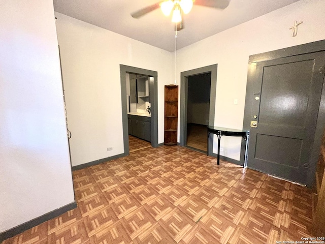 spare room featuring ceiling fan and parquet floors