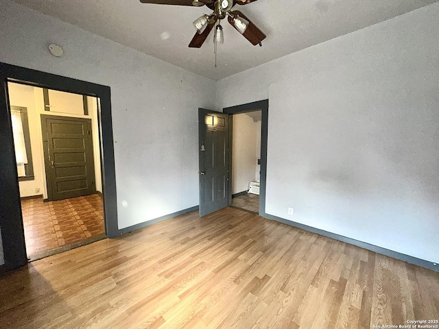 unfurnished bedroom with ceiling fan and light wood-type flooring