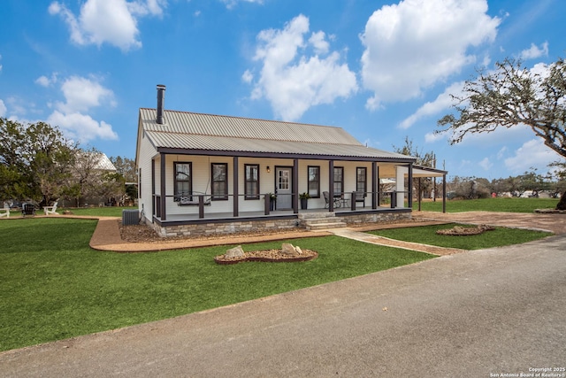 view of front of property featuring cooling unit, covered porch, and a front lawn