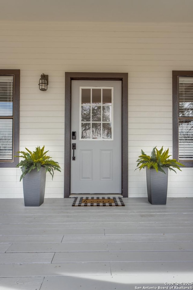 doorway to property featuring covered porch