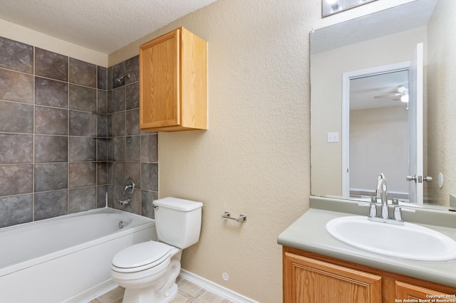 full bathroom with ceiling fan, a textured ceiling, toilet, vanity, and tiled shower / bath