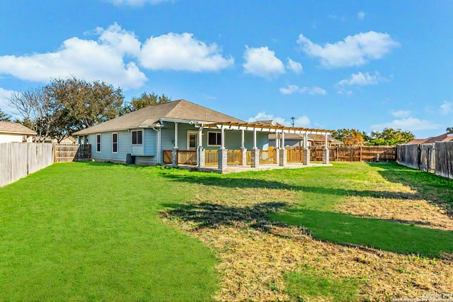 rear view of house with a lawn, a pergola, and a patio