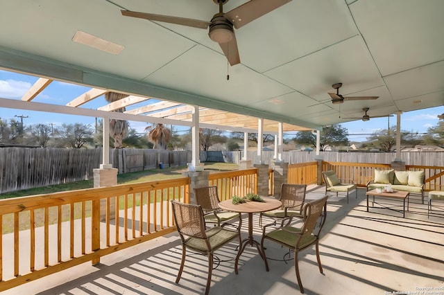 wooden terrace featuring ceiling fan and an outdoor hangout area