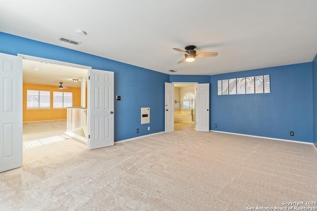 unfurnished bedroom with ceiling fan and light carpet