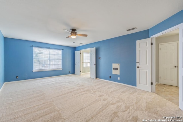 unfurnished bedroom with ceiling fan and light carpet