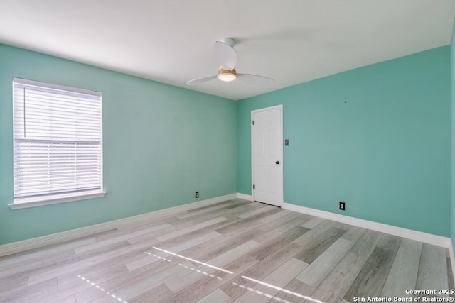 empty room featuring ceiling fan and light hardwood / wood-style flooring