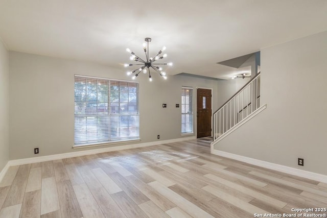 interior space with light wood-type flooring and an inviting chandelier