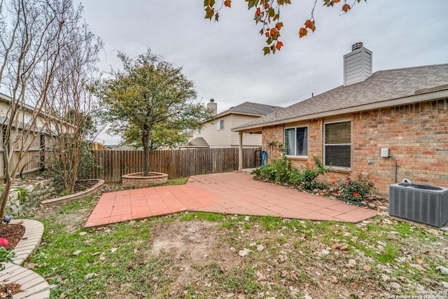 view of yard with a patio area and central air condition unit