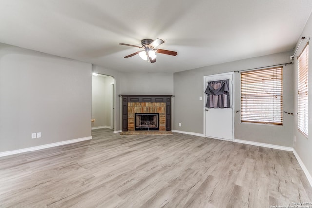 unfurnished living room featuring ceiling fan and light hardwood / wood-style floors