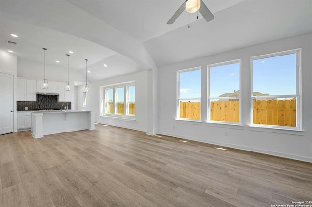 unfurnished living room with ceiling fan and light wood-type flooring