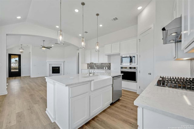 kitchen featuring white cabinetry, pendant lighting, an island with sink, and stainless steel appliances